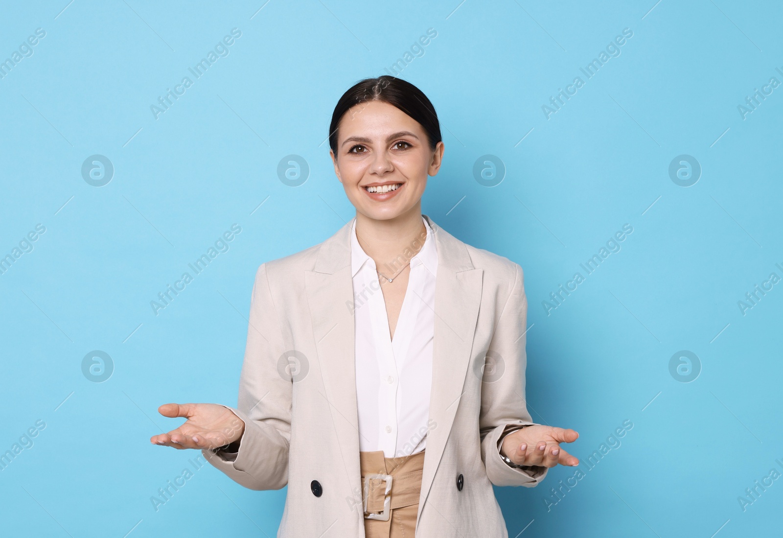 Photo of Portrait of banker in jacket on light blue background