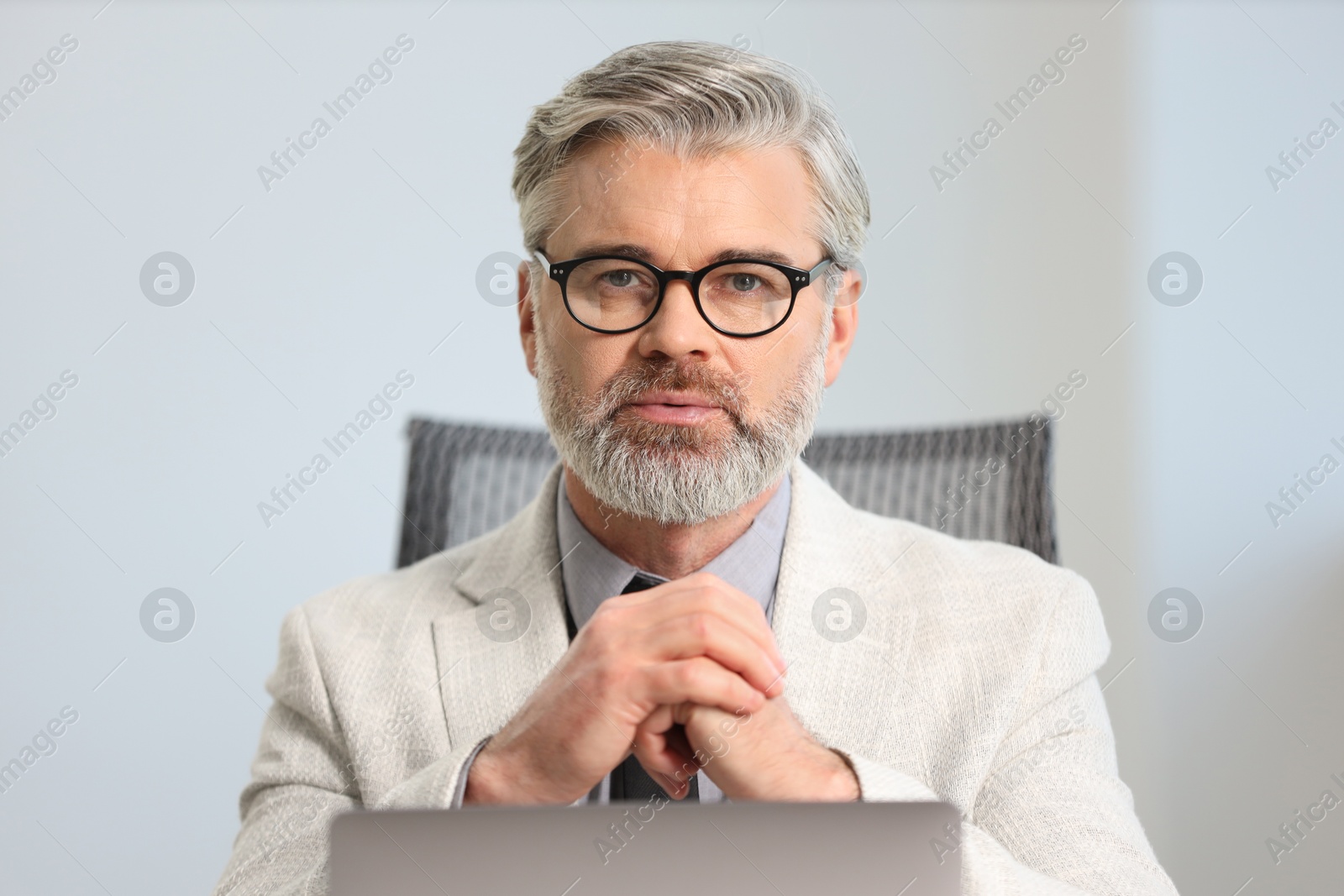 Photo of Portrait of banker with glasses in office