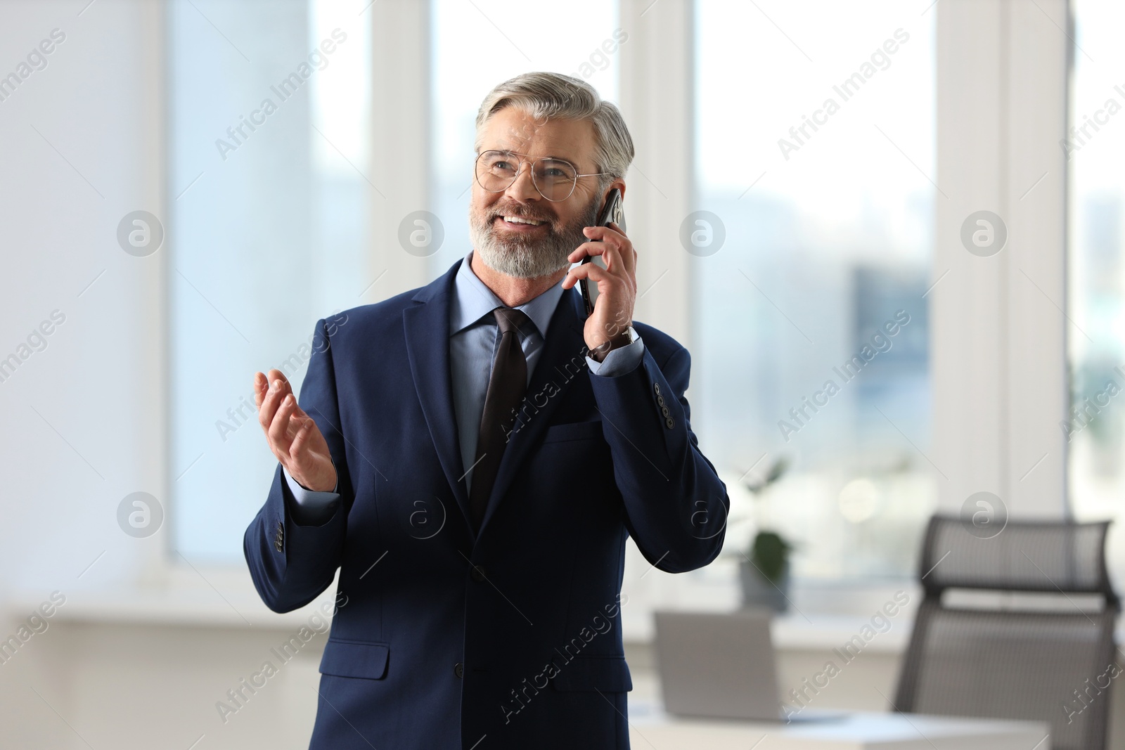 Photo of Banker talking on smartphone in office, space for text