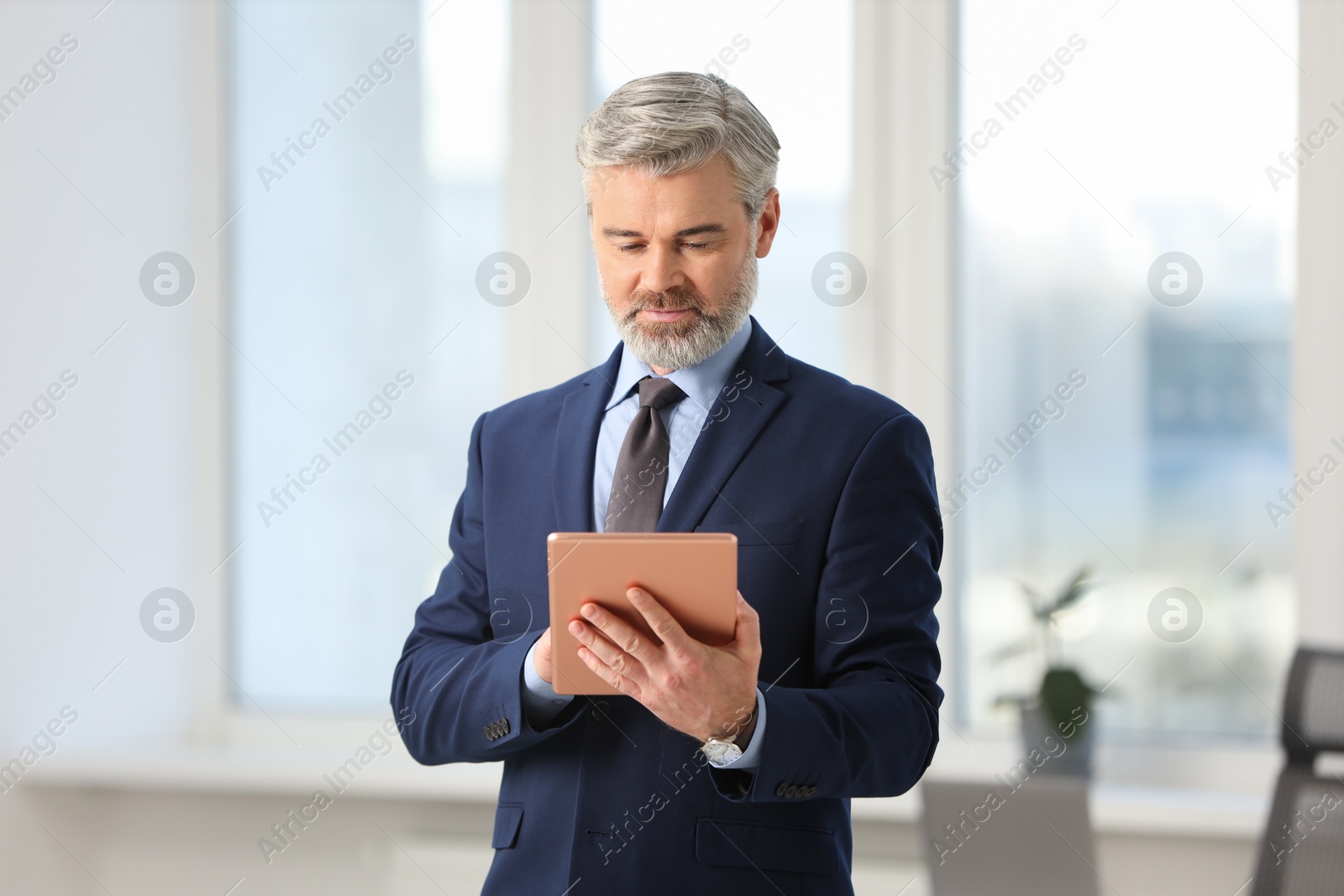 Photo of Portrait of banker with tablet in office