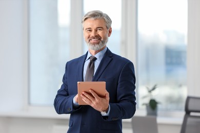 Photo of Portrait of banker with tablet in office