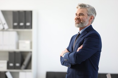 Photo of Portrait of banker with crossed arms in office, space for text