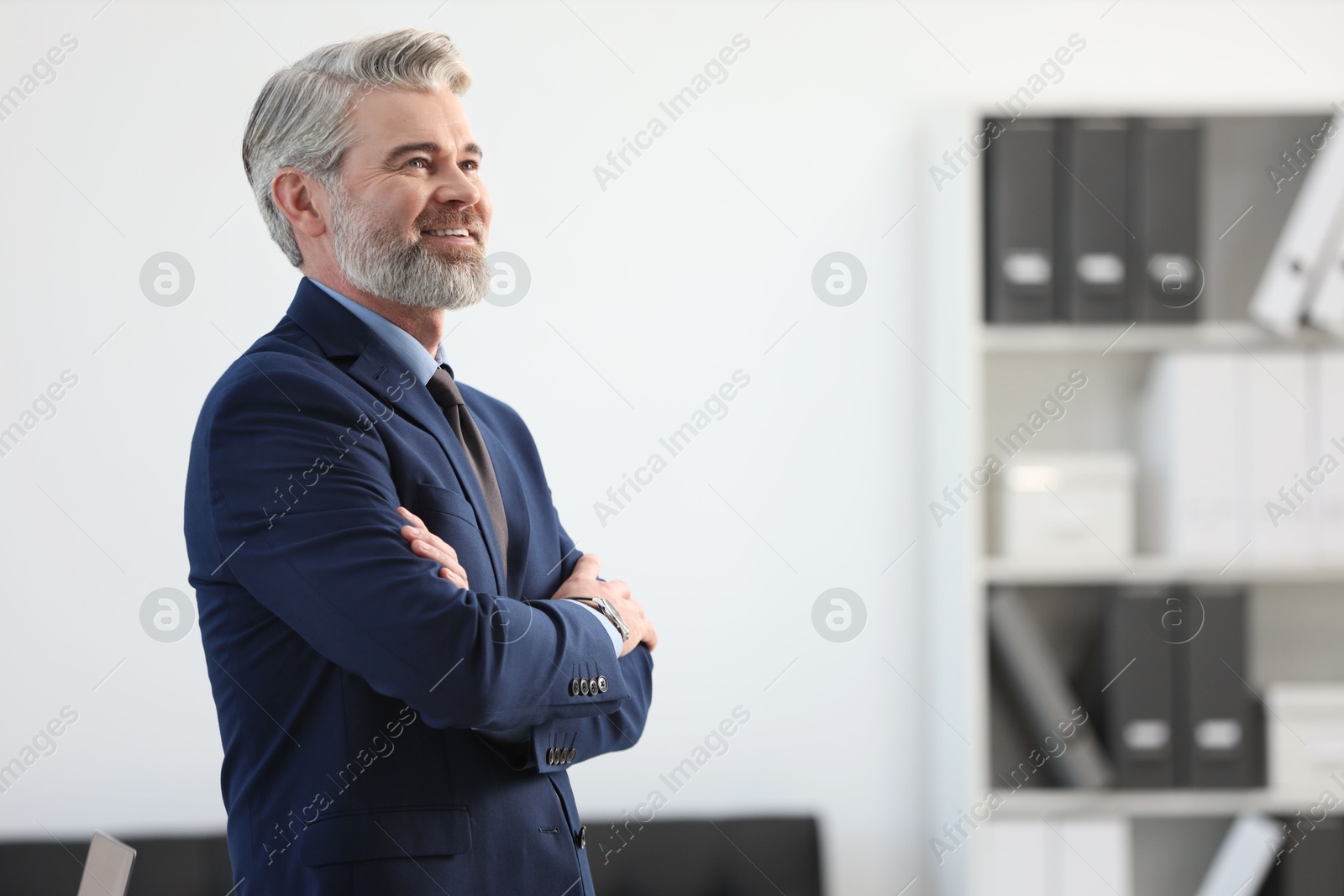 Photo of Portrait of banker with crossed arms in office, space for text