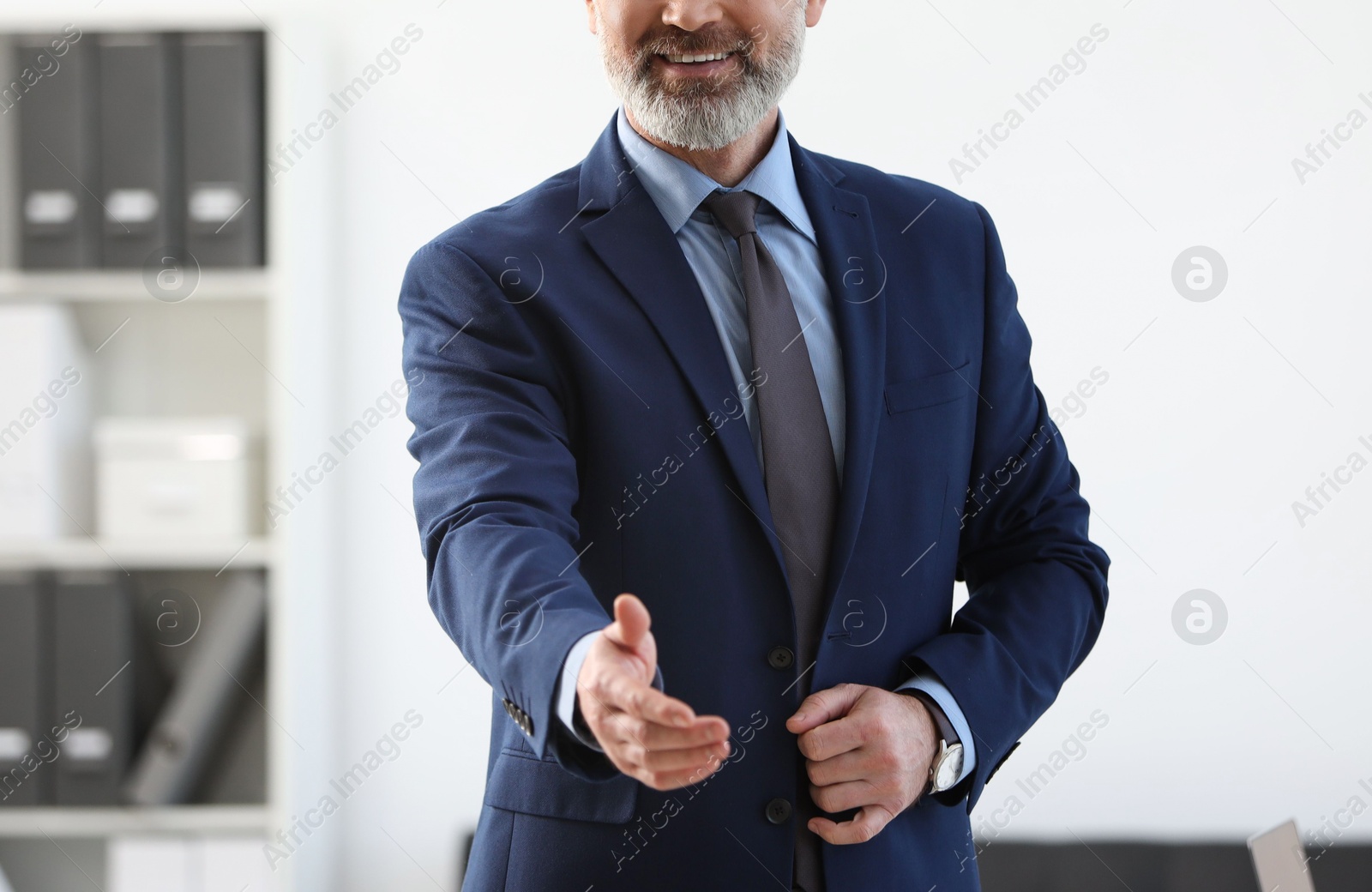 Photo of Smiling banker in jacket indoors, closeup view