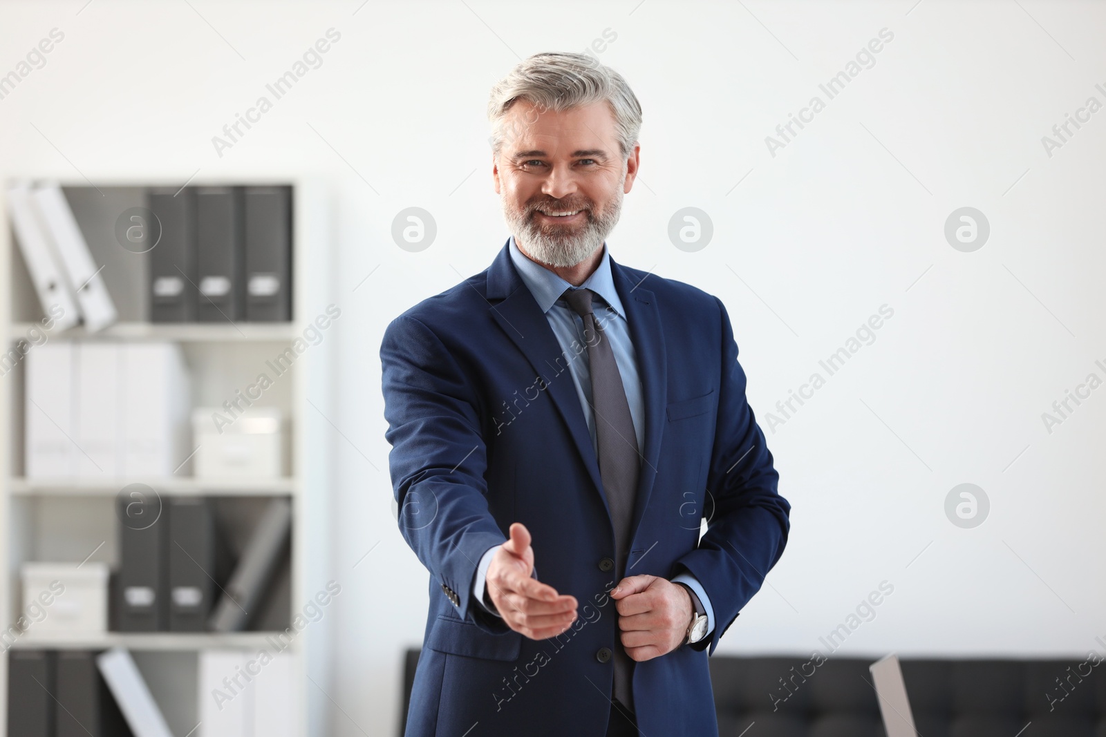 Photo of Portrait of happy banker in jacket indoors