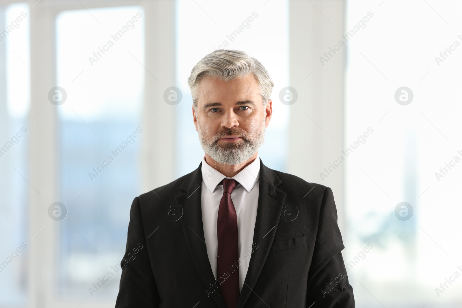 Photo of Portrait of banker in jacket at workplace