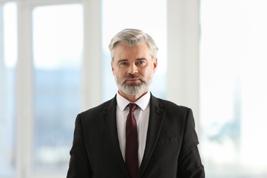 Portrait of banker in jacket at workplace