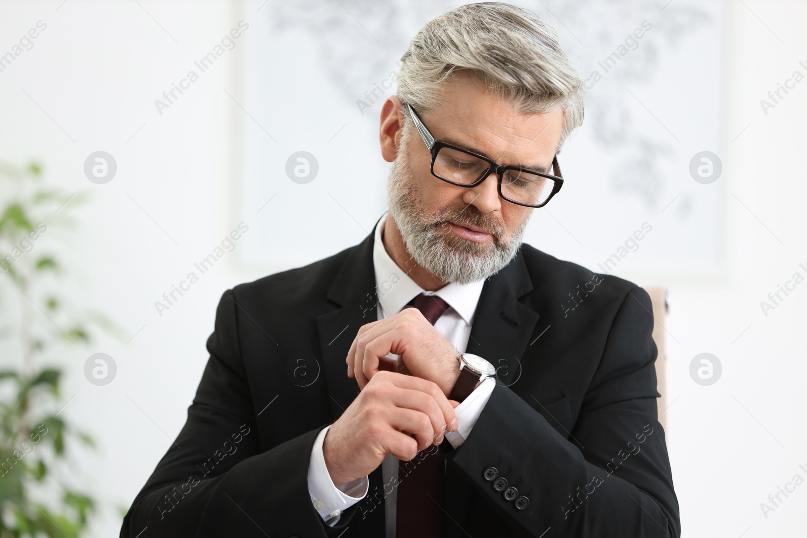 Photo of Portrait of banker with glasses in office