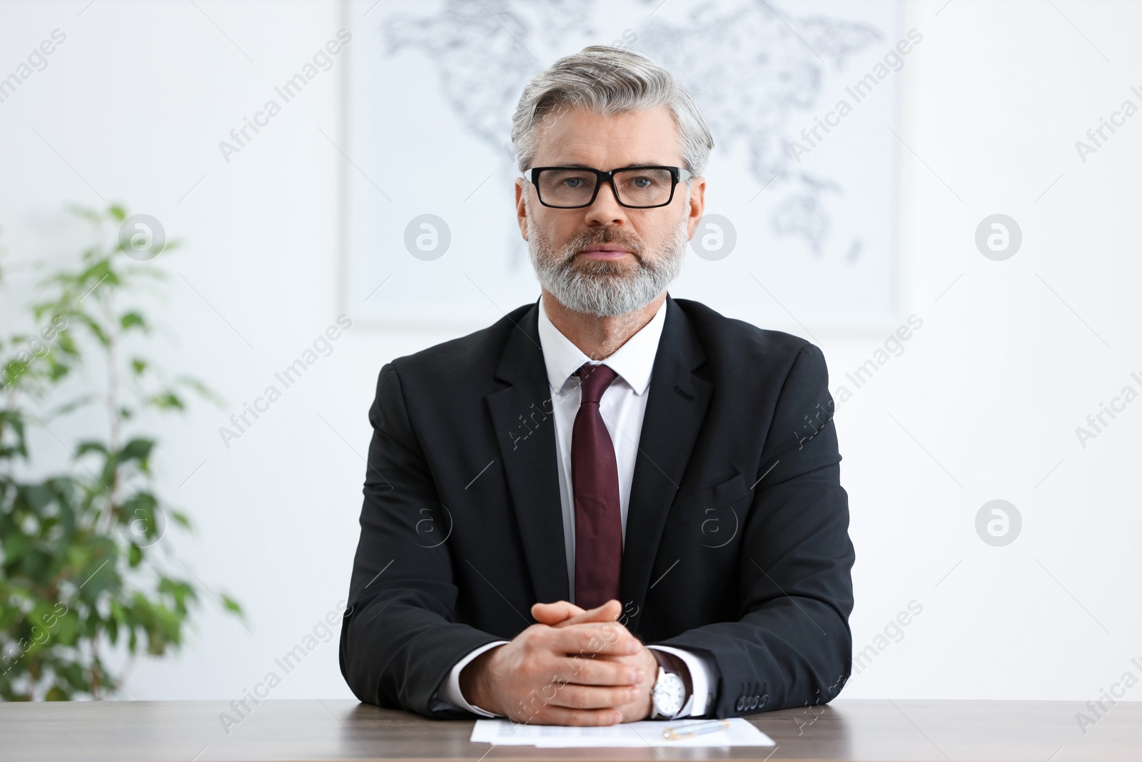 Photo of Banker with glasses at desk in office