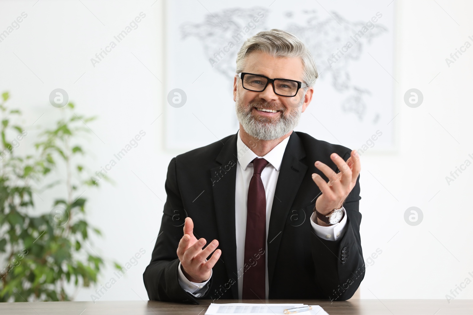 Photo of Banker with glasses at desk in office