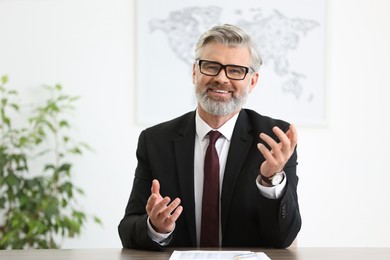 Photo of Banker with glasses at desk in office