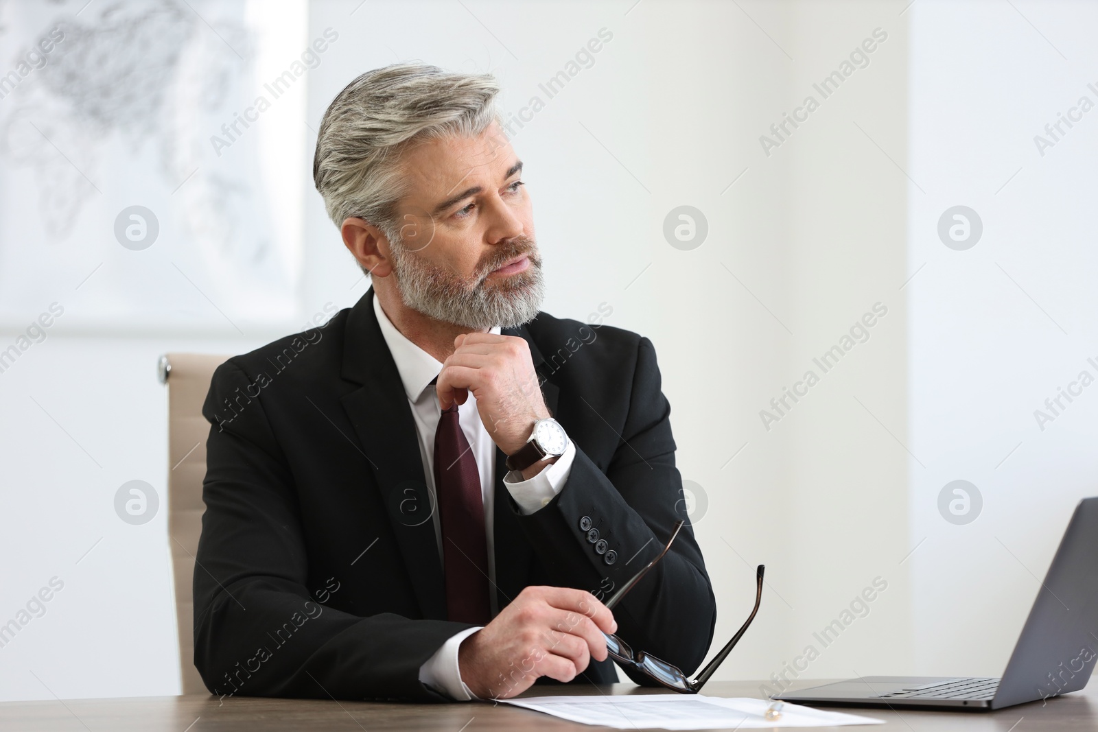 Photo of Banker with glasses at desk in office