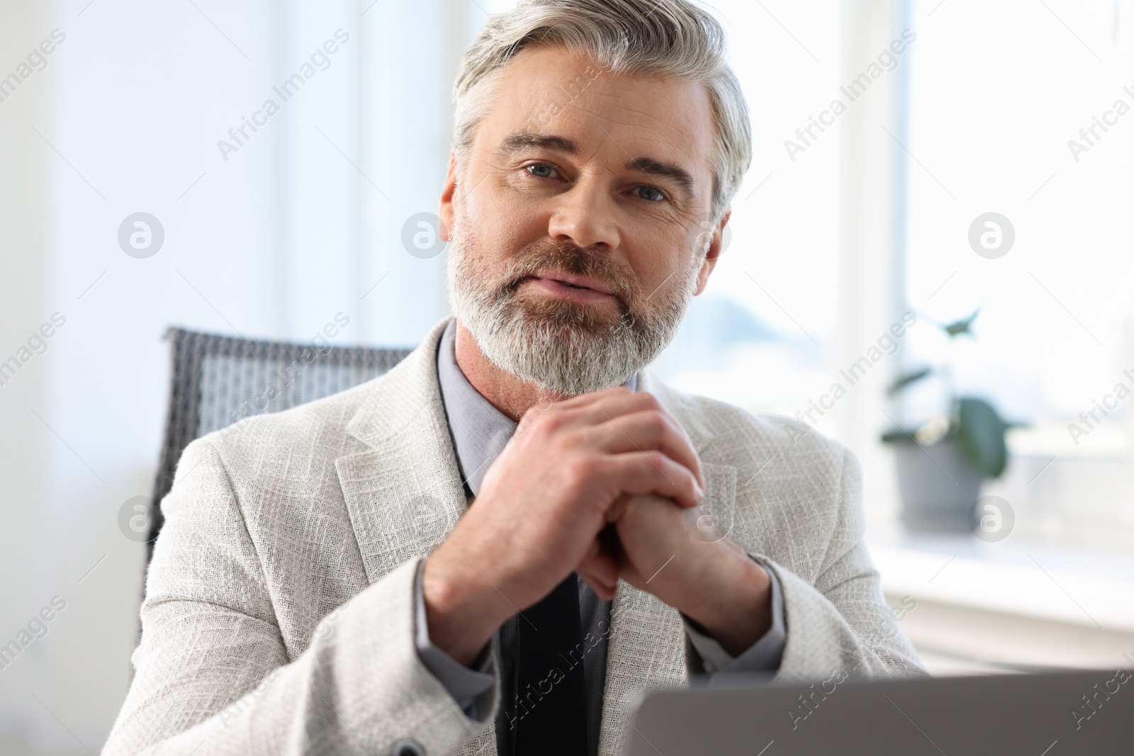 Photo of Portrait of banker in jacket at workplace