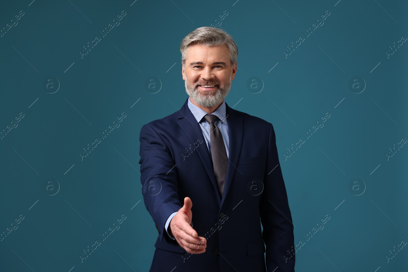 Photo of Portrait of banker in jacket on blue background