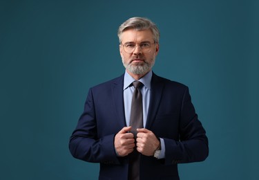 Photo of Confident banker in jacket on blue background