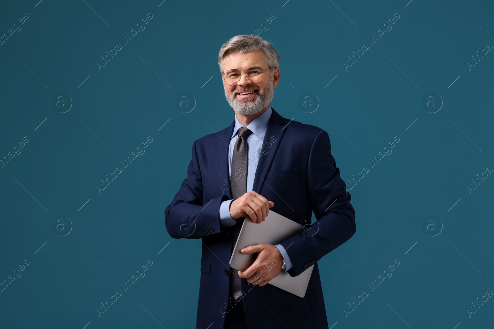 Photo of Smiling banker with laptop on blue background