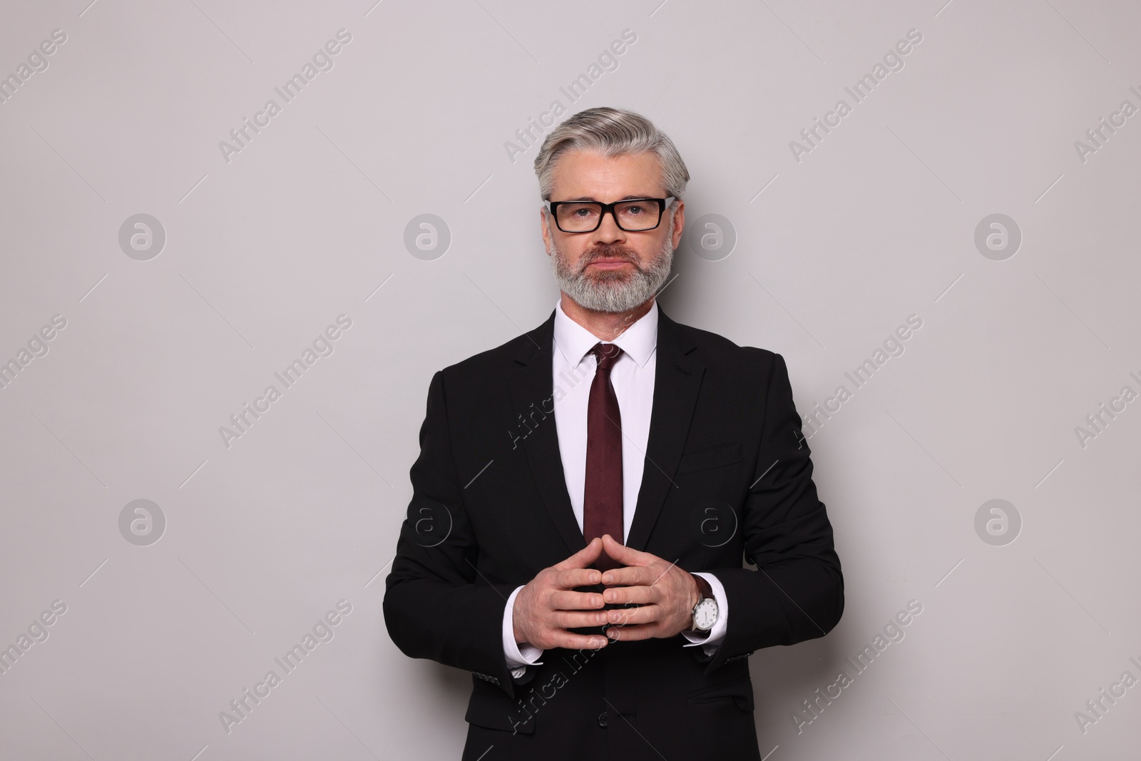 Photo of Portrait of banker in glasses on grey background