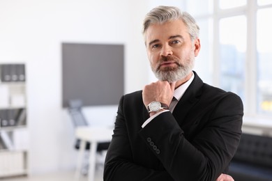 Portrait of banker in jacket indoors, space for text