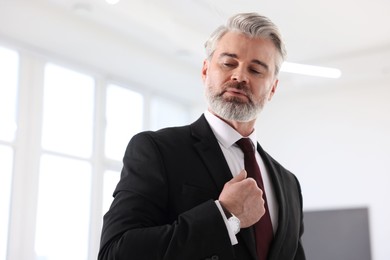 Photo of Portrait of banker in jacket indoors, low angle view