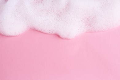 Photo of Sample of fluffy foam on pink background, top view. Space for text