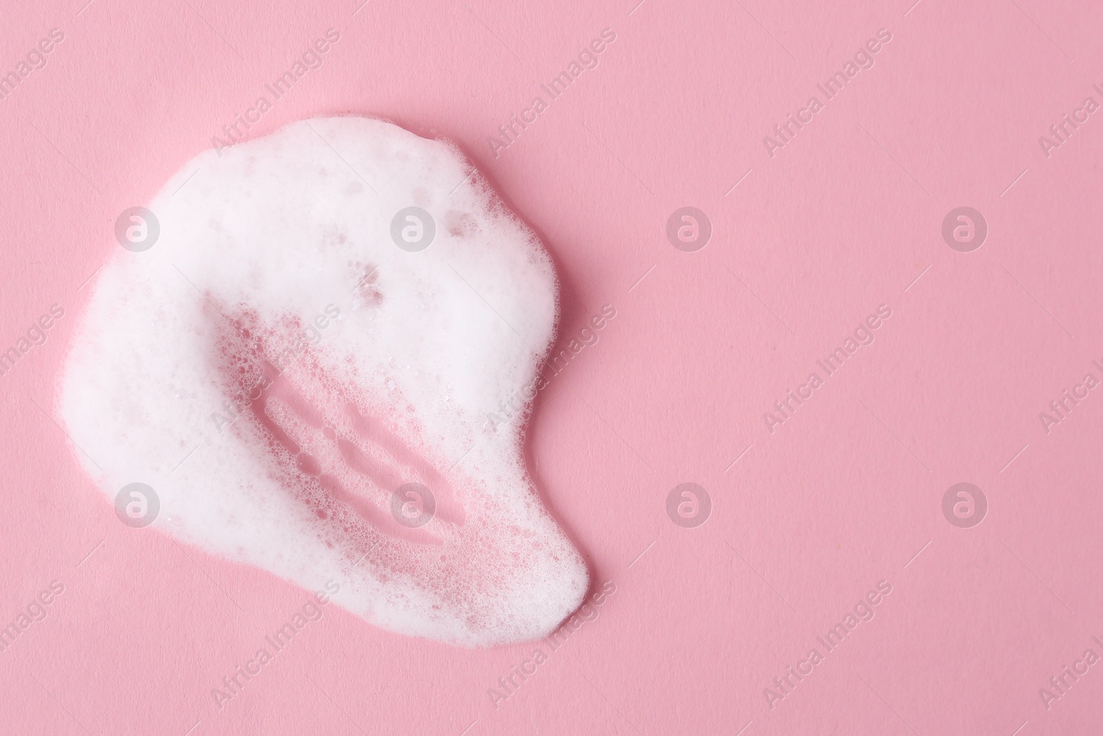 Photo of Sample of fluffy foam on pink background, top view. Space for text