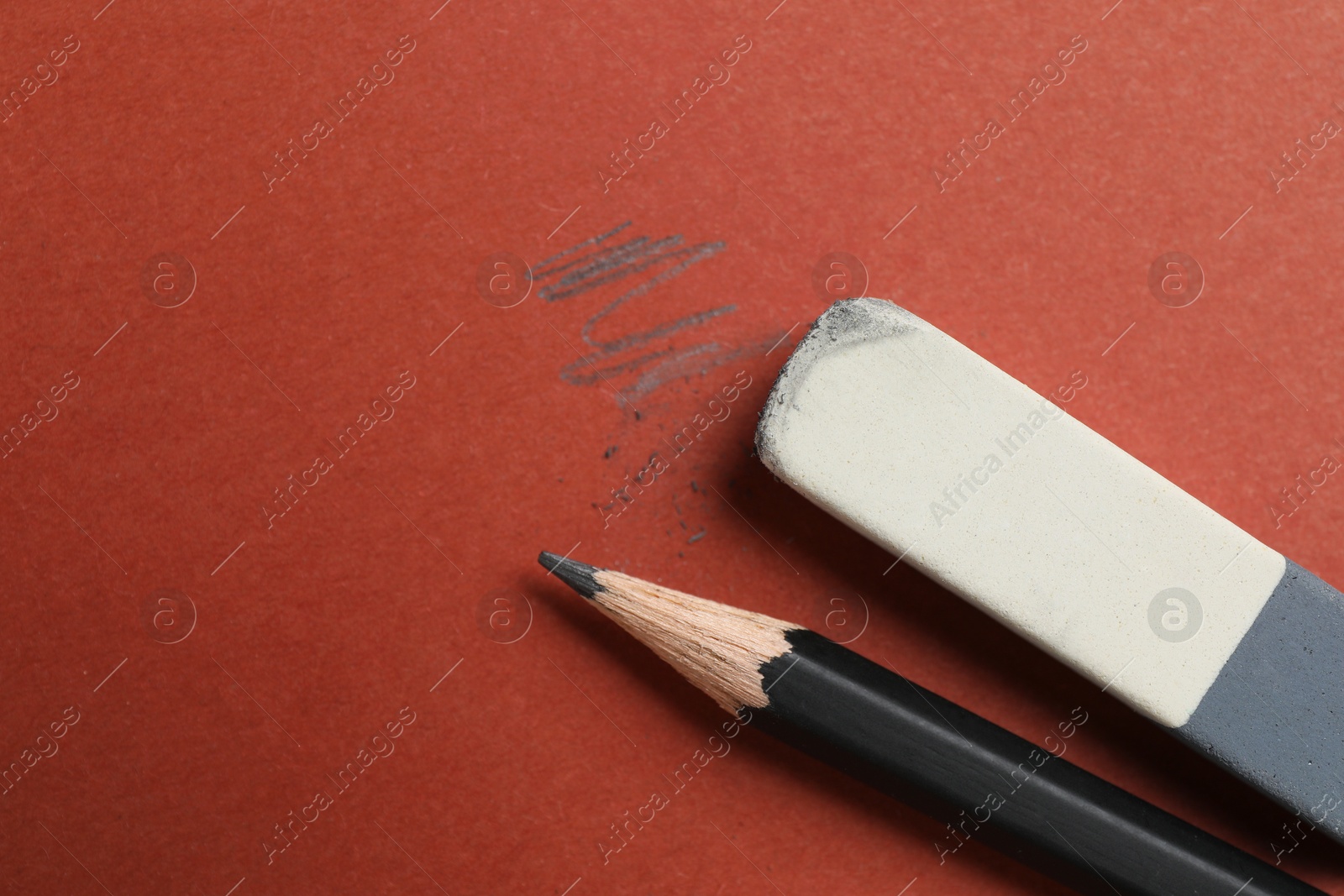 Photo of Eraser and pencil on brown background, flat lay. Space for text