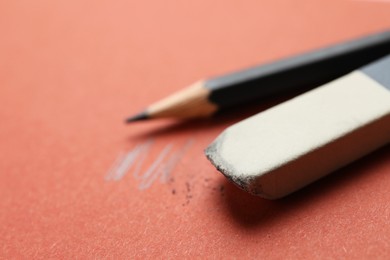 Photo of Eraser and pencil on brown background, closeup. Space for text