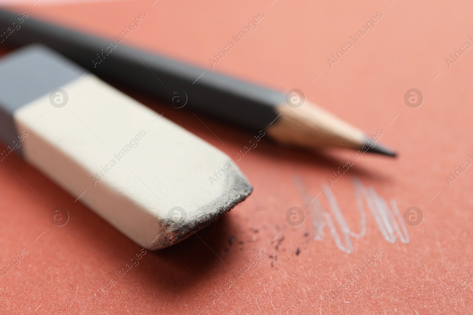 Photo of Eraser and pencil on brown background, closeup. Space for text