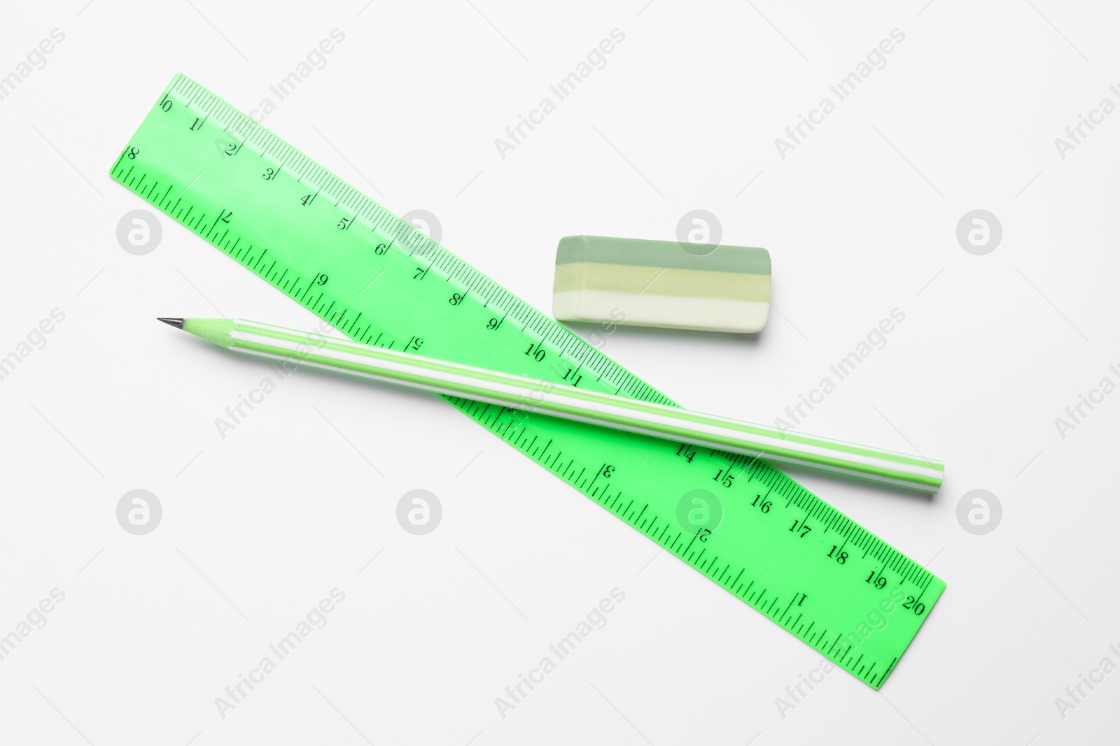 Photo of Eraser, pencil and ruler on white background, flat lay