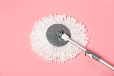 String mop on pink background, above view