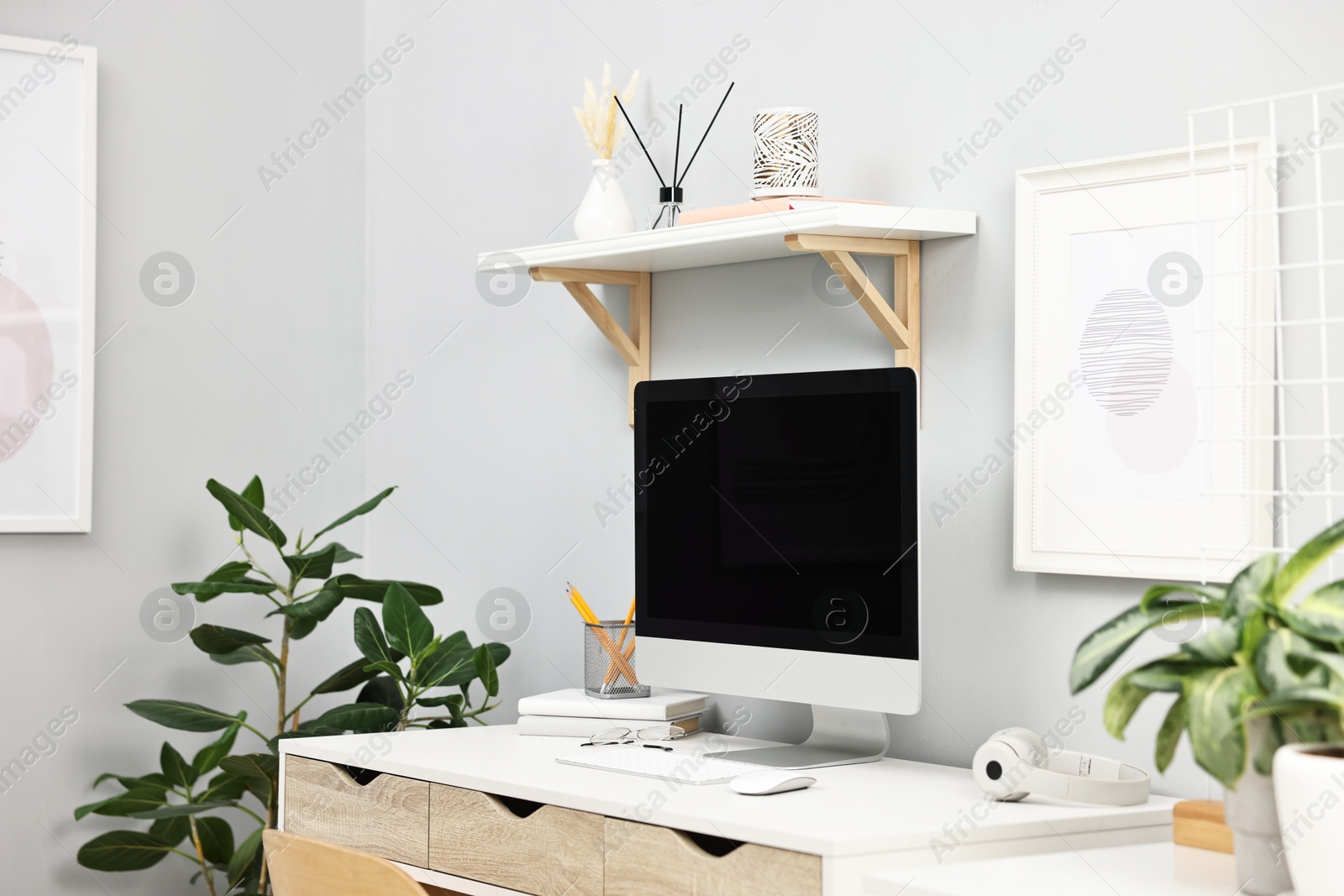 Photo of Comfortable workplace with modern computer on white table indoors