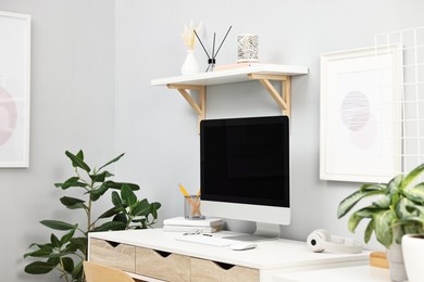 Photo of Comfortable workplace with modern computer on white table indoors