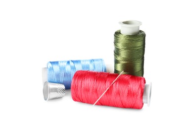 Photo of Spools of thread and other sewing supplies isolated on white