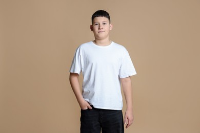 Photo of Portrait of teenage boy on beige background