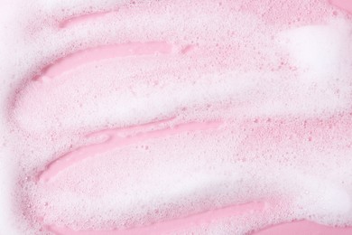 Photo of Sample of fluffy foam on pink background, top view