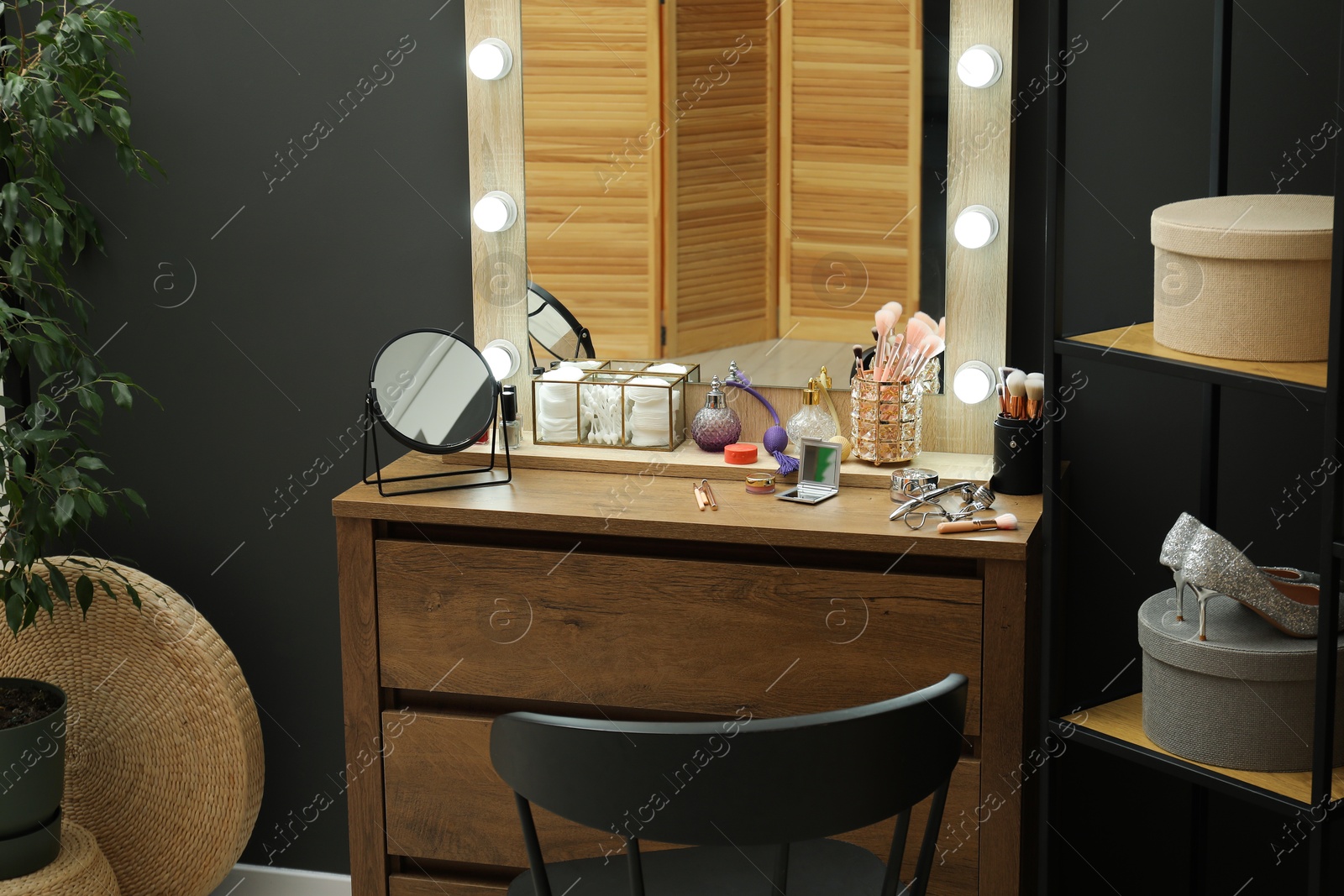 Photo of Makeup room. Mirrors, different beauty products, shoes, dresser and chair indoors