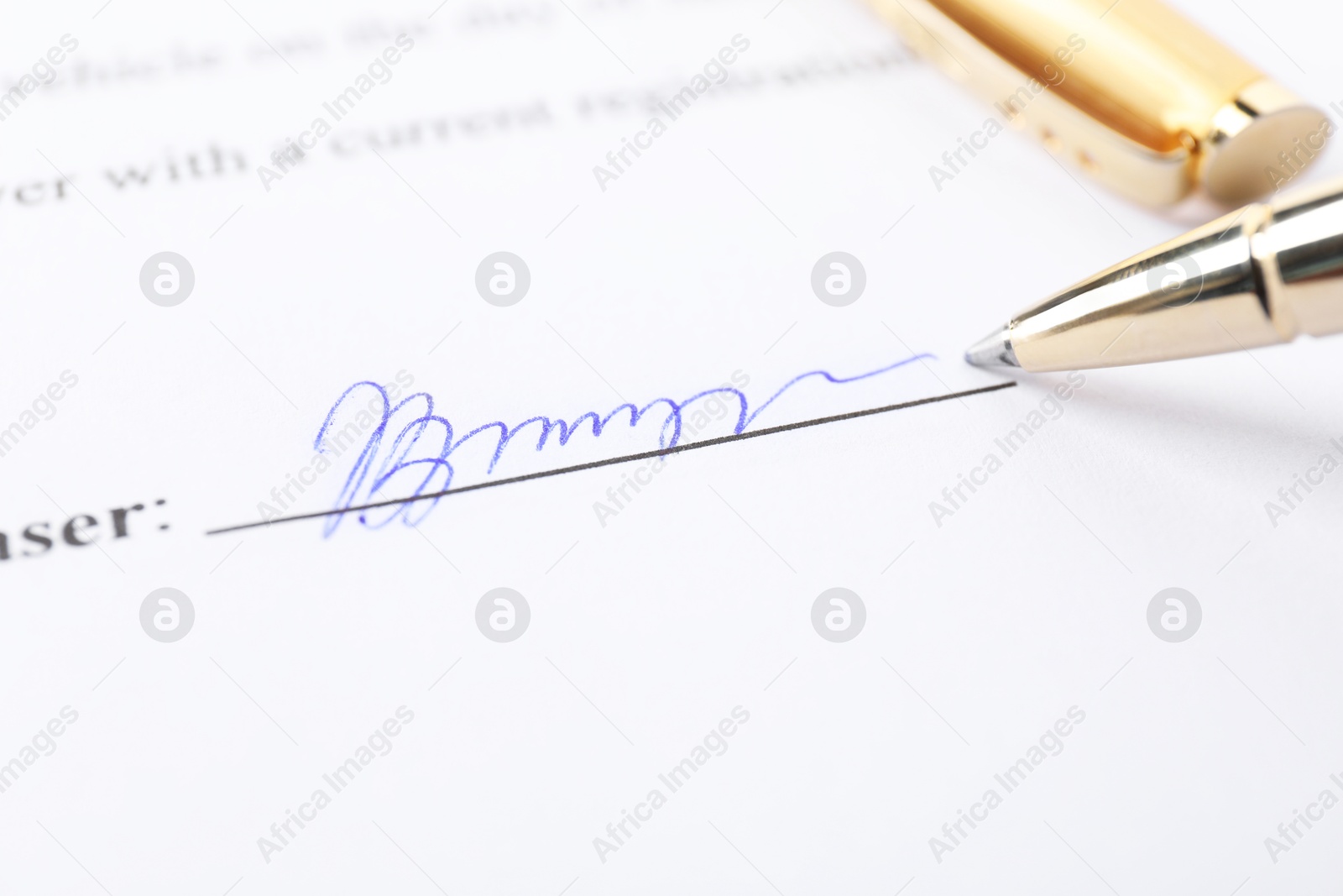 Photo of Pen leaving signature on contract, closeup view