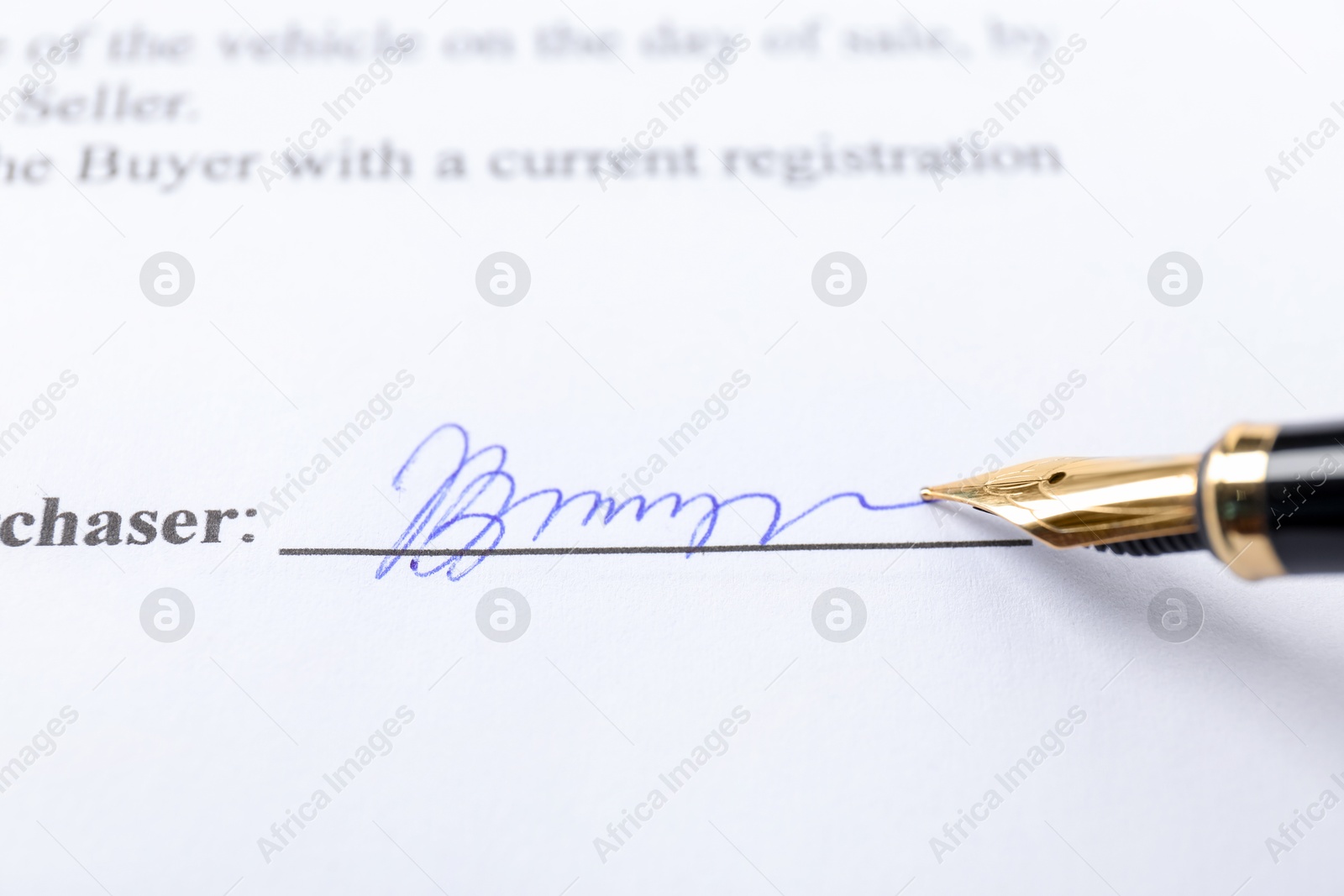 Photo of Fountain pen leaving signature on contract, closeup