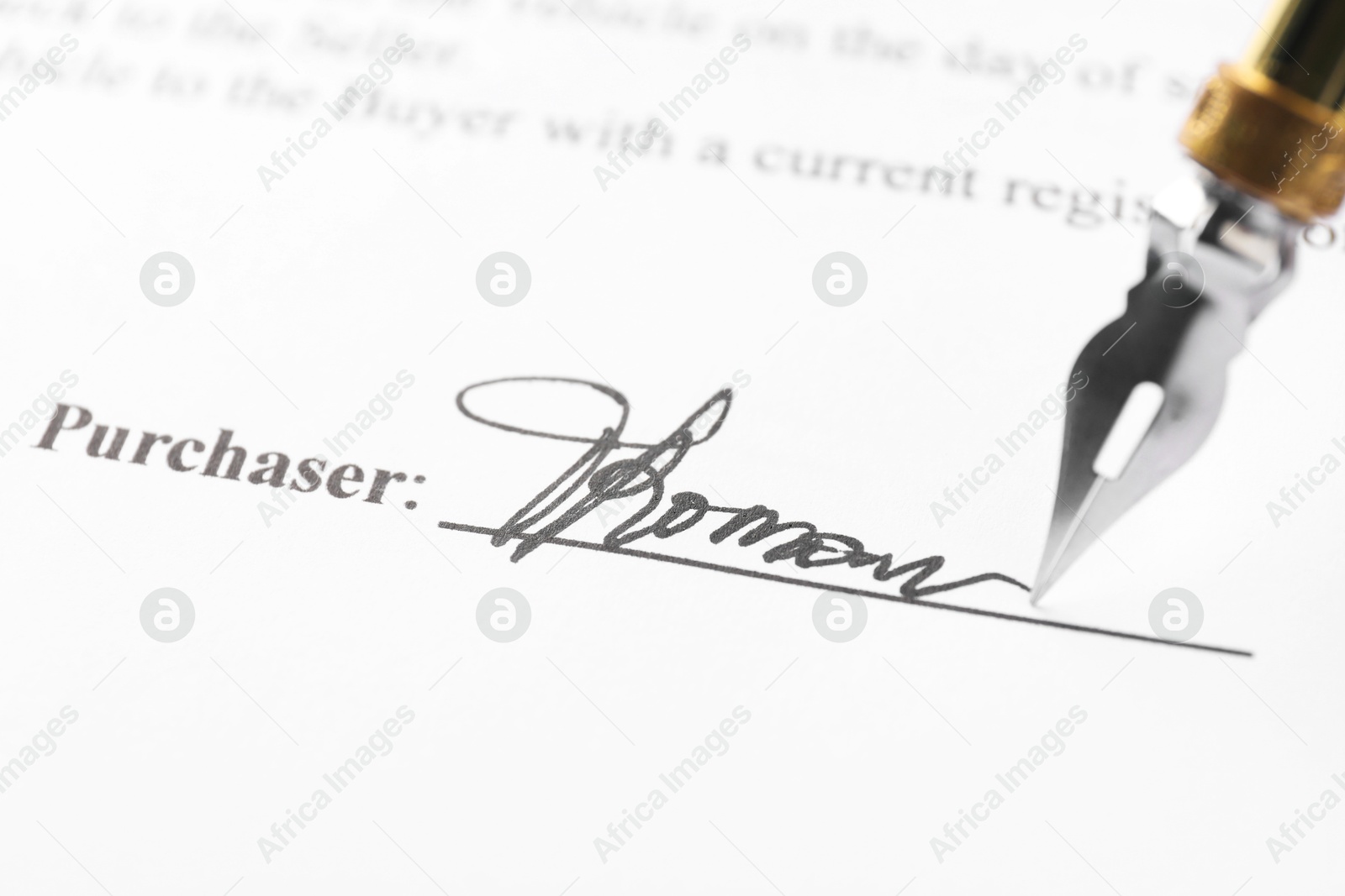 Photo of Fountain pen leaving signature on contract, closeup