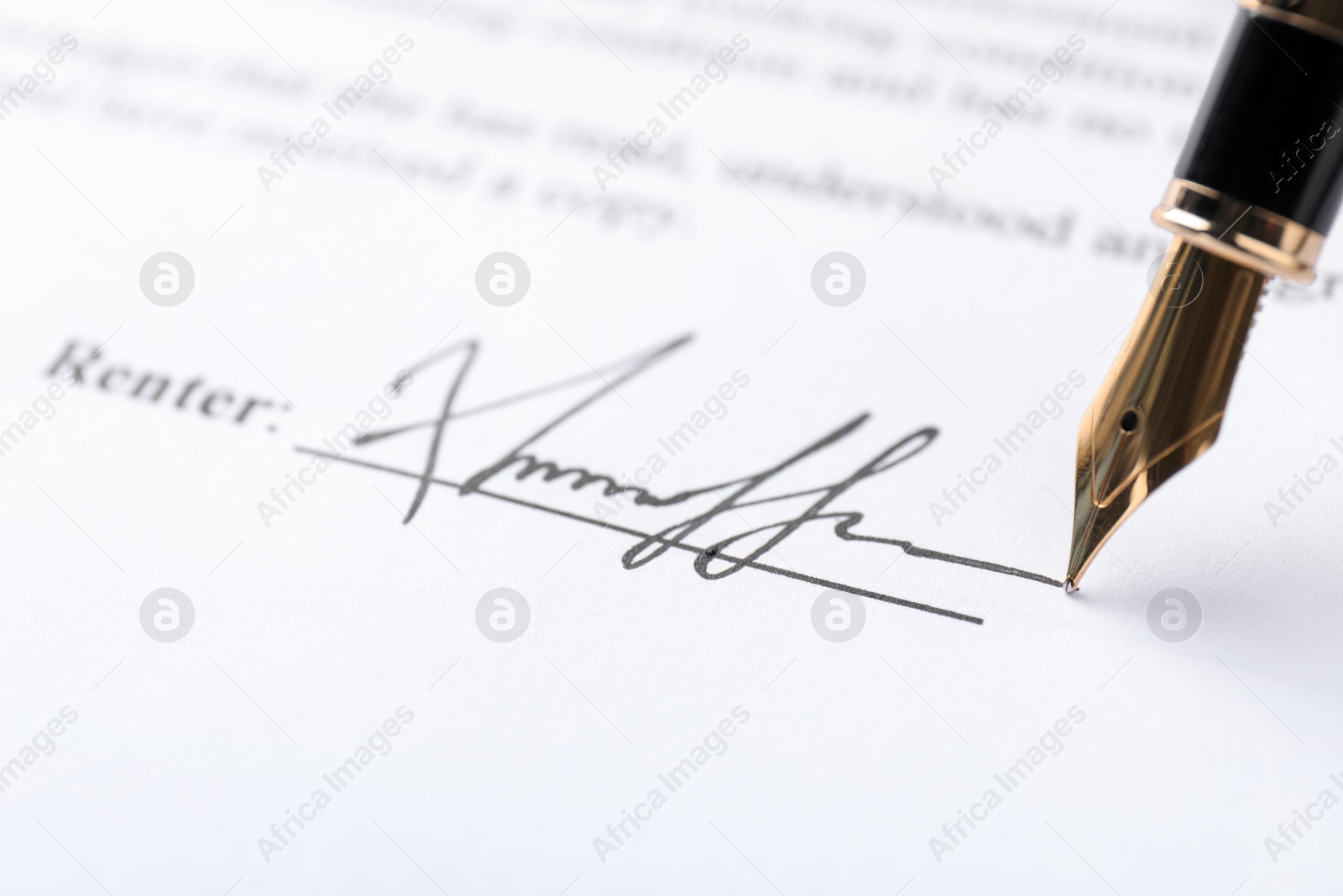 Photo of Fountain pen leaving signature on contract, closeup