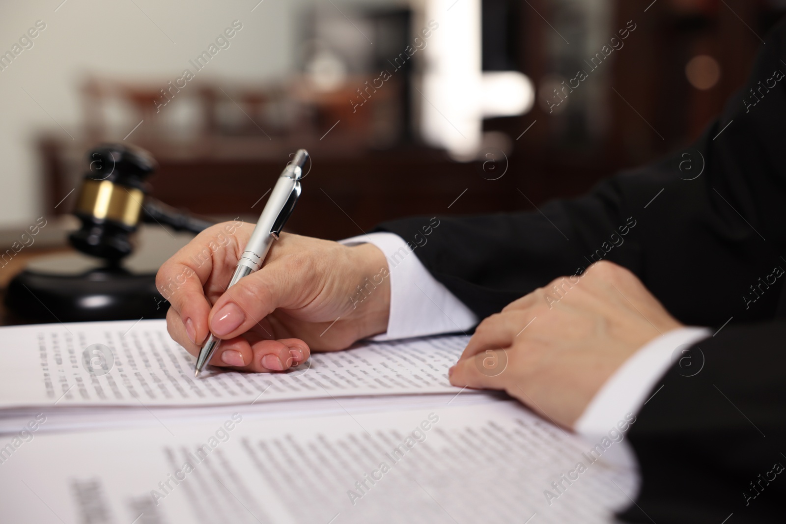 Photo of Judge working at table in office, closeup