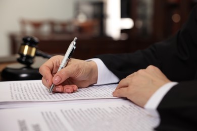 Photo of Judge working at table in office, closeup