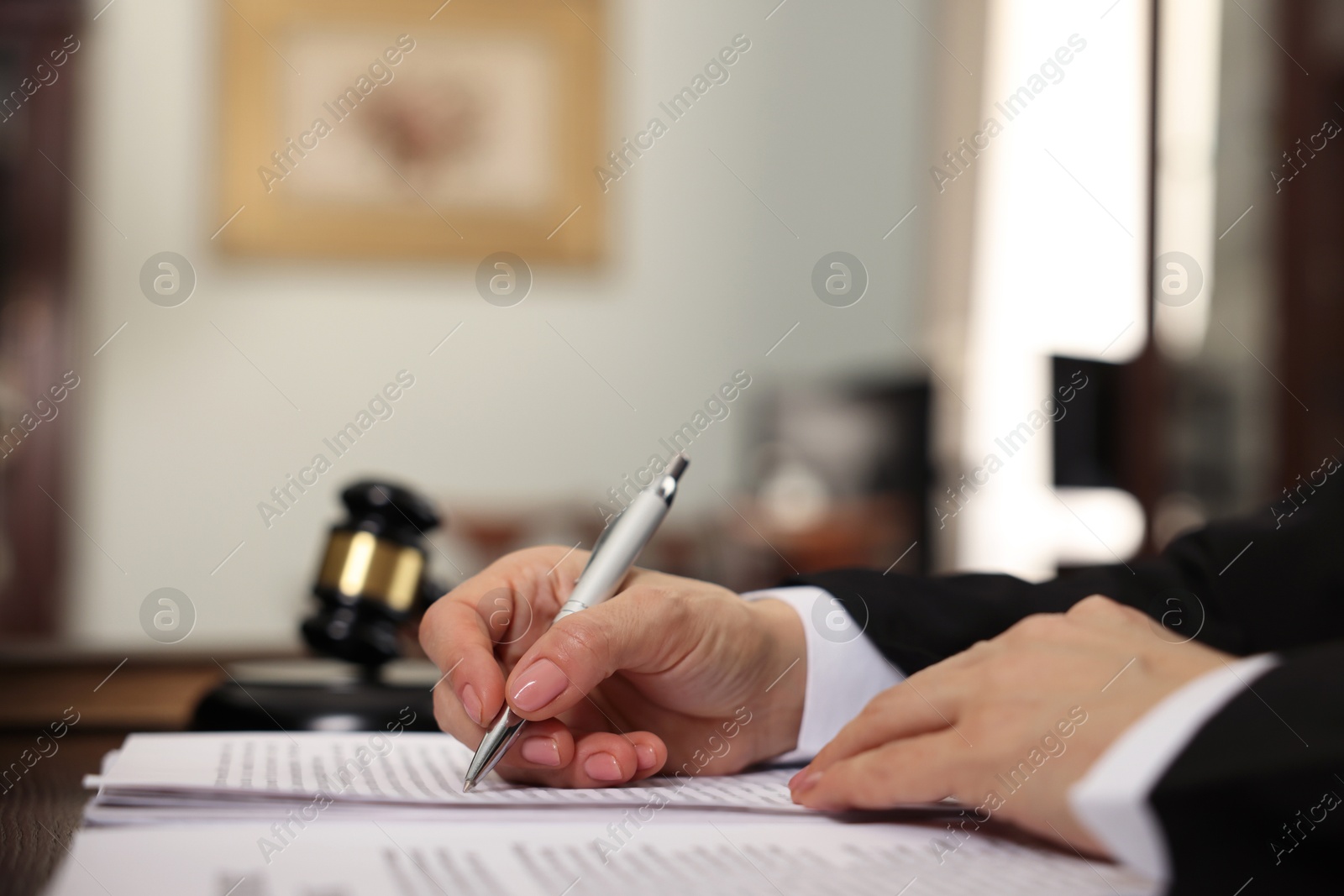 Photo of Judge working at table in office, closeup