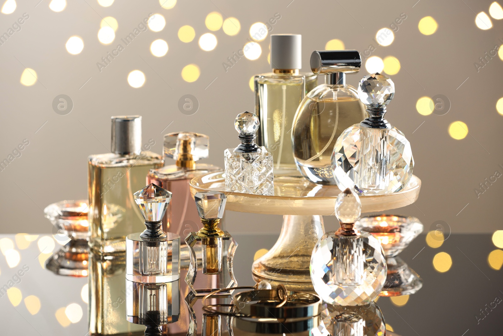 Different luxury perfumes on glass surface. Bokeh effect Photo of Different luxury perfumes on glass surface. Bokeh effect