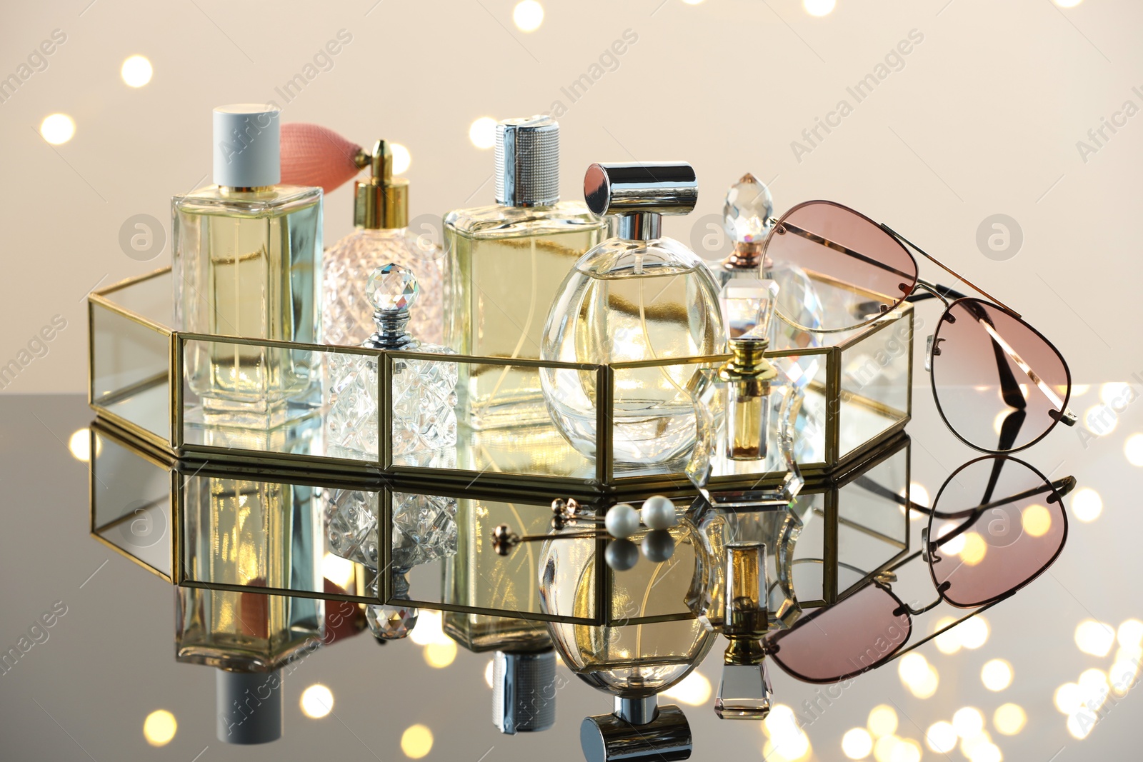 Different luxury perfumes on glass surface. Bokeh effect Photo of Different luxury perfumes on glass surface. Bokeh effect