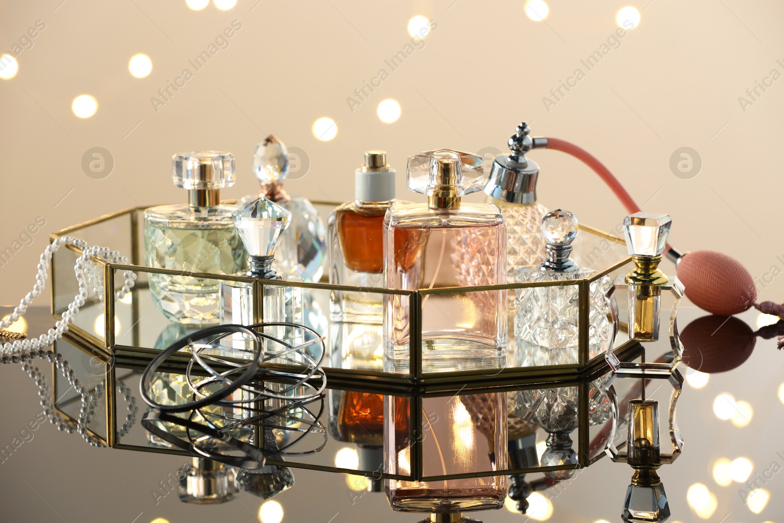 Different luxury perfumes on glass surface. Bokeh effect Photo of Different luxury perfumes on glass surface. Bokeh effect