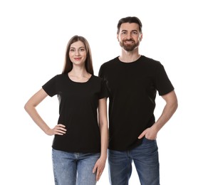 Photo of Woman and man wearing blank black t-shirts on white background. Mockup for design