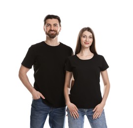 Woman and man wearing blank black t-shirts on white background. Mockup for design