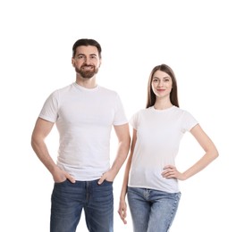 Photo of Woman and man wearing blank t-shirts on white background. Mockup for design