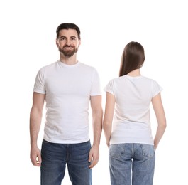 Photo of Woman and man wearing blank t-shirts on white background. Mockup for design